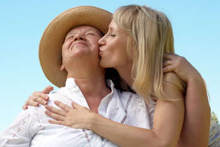 The daughter kissing  mother outdoorsの写真素材