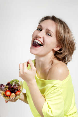 The beautiful young girl with fruit saladの写真素材