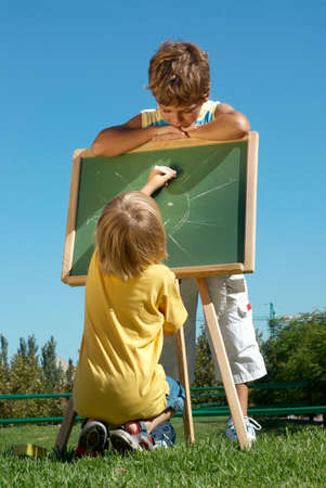 Two boys drawing on fresh airの写真素材