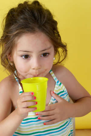 The little girl with a water glassの写真素材