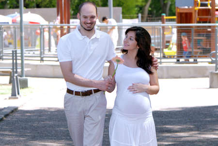Happy beautiful pregnant woman and her husbandの写真素材