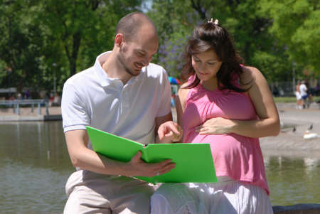 Happy beautiful pregnant woman and her husbandの写真素材