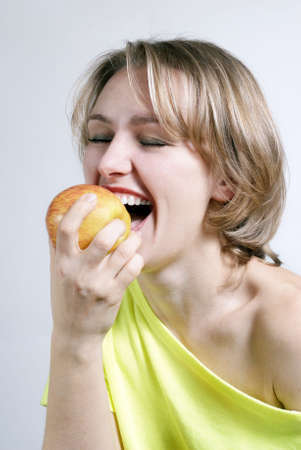 The beautiful young girl with a applleの写真素材