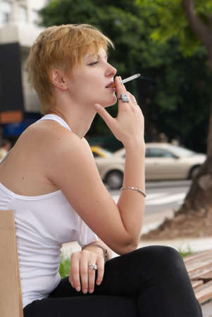 The girl with a cigarette outdoorsの写真素材