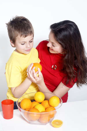Mother with the son and orangesの写真素材