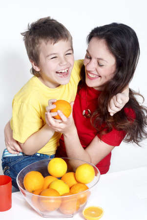 Mother with the son and orangesの写真素材
