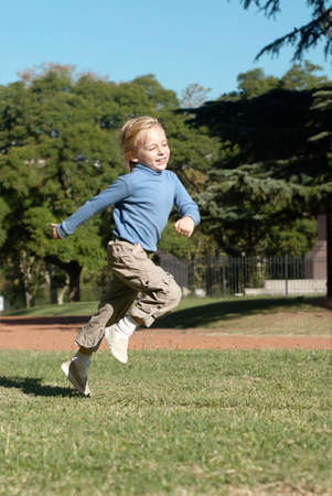 The boy running in parkの写真素材