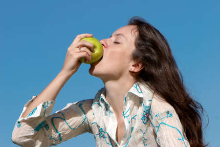 The girl with an green appleの写真素材
