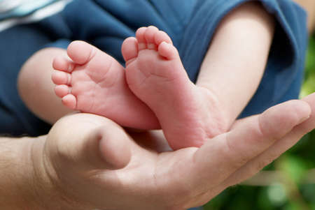 Children's legs on a parent handの写真素材