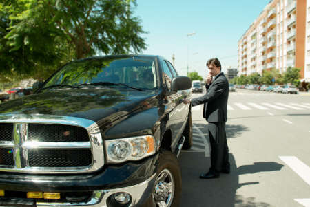 Young businessman by modern carの写真素材