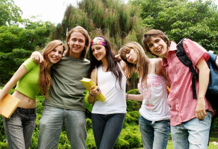 Portrait happy young students in parkの写真素材