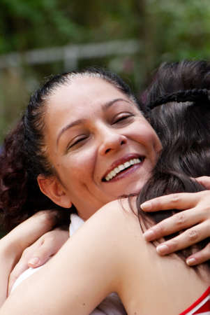 Portrait of happy mother in embraces of a daughterの写真素材