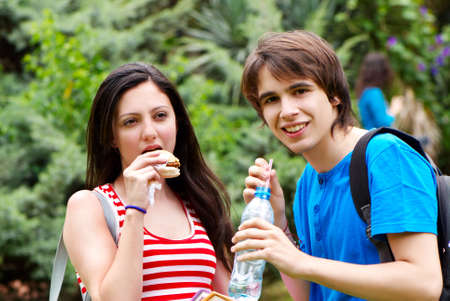 students during a lunch break in parkの写真素材
