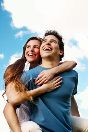 Happy Young couple against the sky