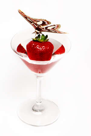 strawberries in glass on white background and butterflyの写真素材