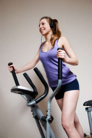 Girl on training apparatus  in sportclubの写真素材