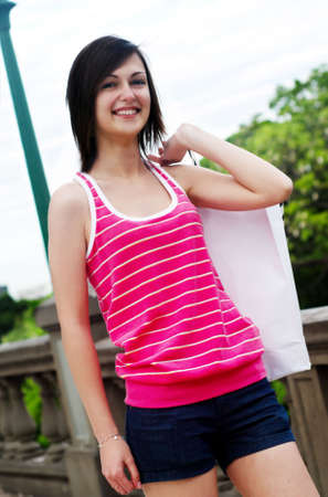 Beautiful teenager with a shopping bagの写真素材