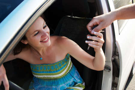 The happy woman during car purchase