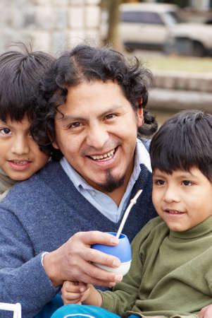 Latin family sitting in the streetの写真素材