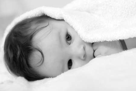 Little baby under white towelの写真素材