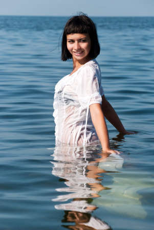 The girl in a white dress against the seaの写真素材