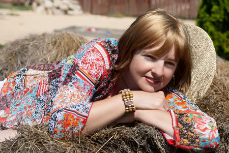 women lean on a haystack の写真素材