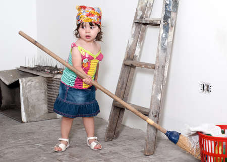 The little girl with a broom with handsの写真素材