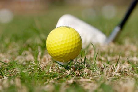 A golf ball and driver with focus on the ballの写真素材