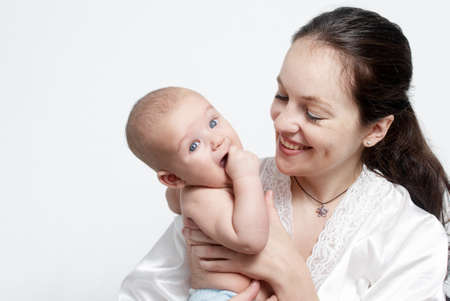 Portrait baby with happy mother on light background