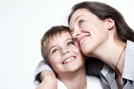 Happy mother with the son isolated on light backgroundの写真素材