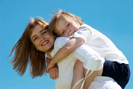 The mother with small son against sky