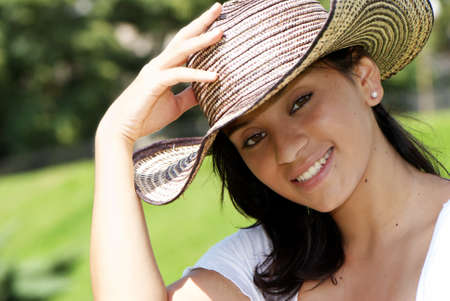 The beautiful Colombian girl in a hatの写真素材