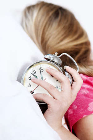 Girl in bed with alarm clock
の写真素材