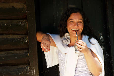 Portrait of the Latin American woman drinking a mateの写真素材