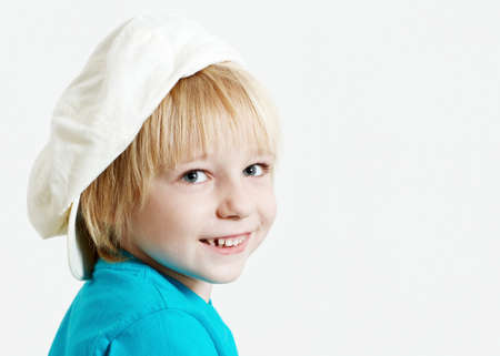 Portrait boy in cap on a light  backgroundの写真素材