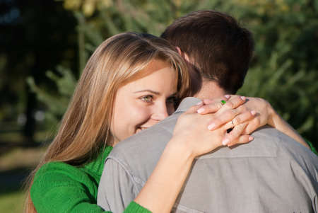 Beautiful mature woman hugging her husband with love の写真素材