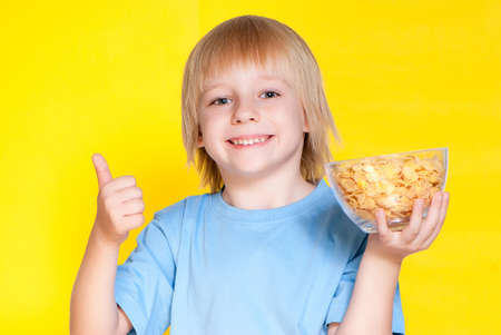 Blond boy kid child eating corn flakes cerealの写真素材