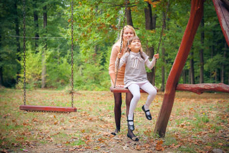 Portrait Of Mother And Child Relaxing In Parkの写真素材