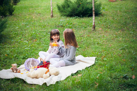 Happy little girlfriends in parkの写真素材