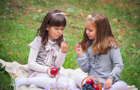 Happy little girlfriends in parkの写真素材