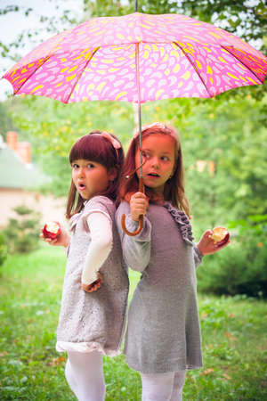 Happy little girlfriends in parkの写真素材