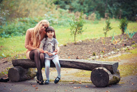 happy young mother with the daughter in parkの写真素材