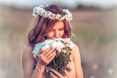 beautiful girl in a camomile wreathの写真素材