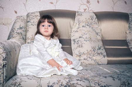 Baby dressed in white dressの写真素材