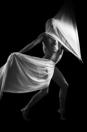 eautiful woman with white tissue on black backgroundの写真素材
