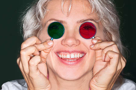the cheerful girl the doctor with multi-colored glasses in the eyes