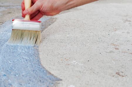 Coating the concrete floor with a brushの写真素材