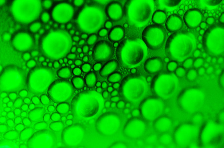 Close up condensed water drops colored green