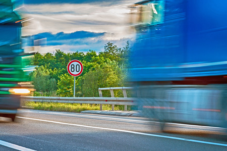 Maximum speed limit and two trucks in motion