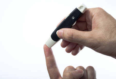 Getting a drop of blood for diabetes controlの写真素材